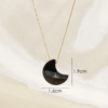 Un collier avec un pendentif lune noire